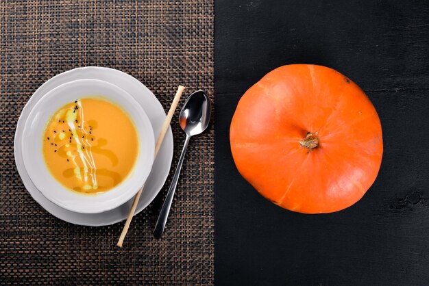 Pumpkin Soup On a wooden surface Top view Free space for your text