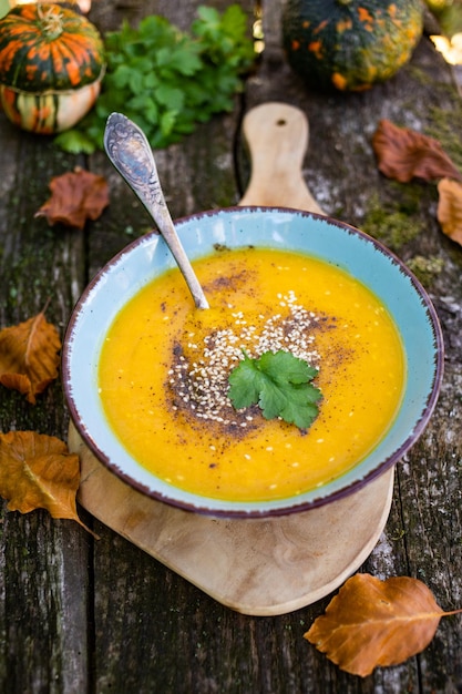 Pumpkin soup on wooden table autumn dish