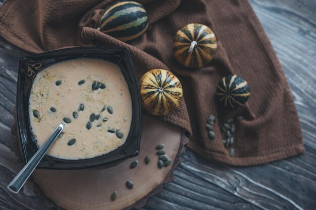 Pumpkin soup on a wooden table top view