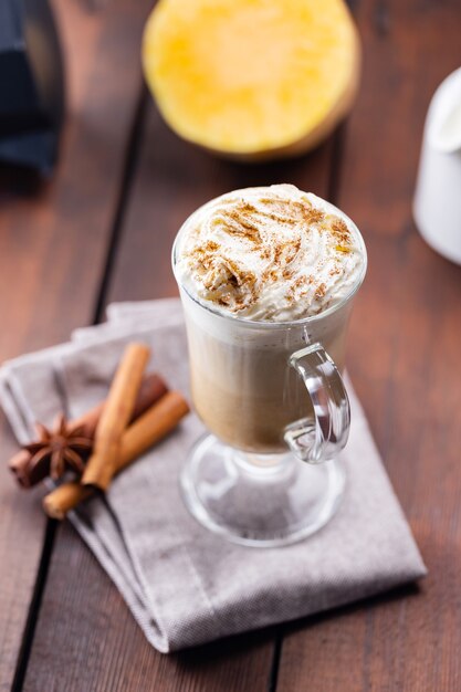 Pumpkin spice latte in a glass mug