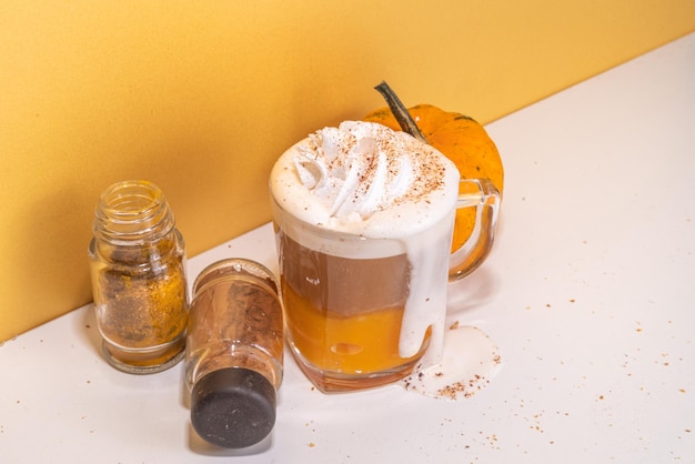 Pumpkin spice latte in a glass mug