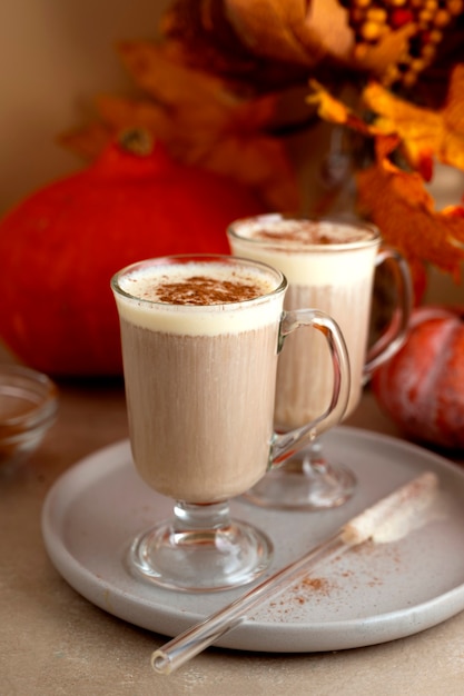 Pumpkin spice latte with whipped milk. Season warm drink with cinnamon, autumn drink.