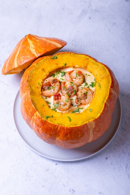 Pumpkin stuffed with shrimps and cheese, whole baked. Traditional Brazilian dish.