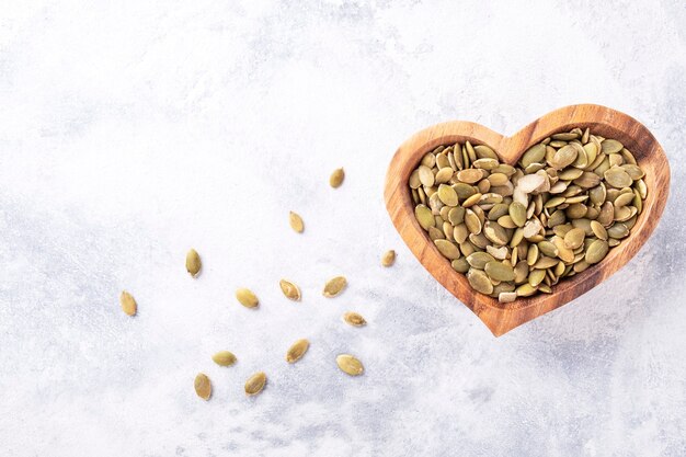 Pumpkin sunflower seeds in a wooden bowl