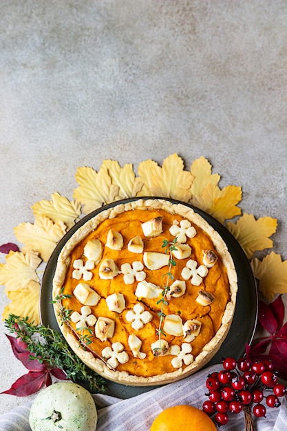 Pumpkin tart or pie with feta and thyme Fall season concept Cozy autumn food background