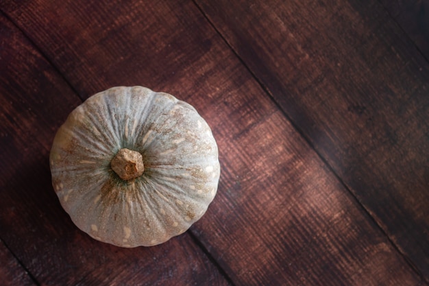 Pumpkin on wooden background with copyspace for adding text