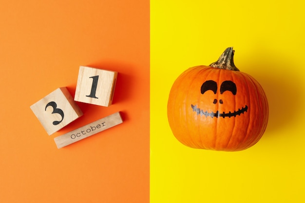 Pumpkin and wooden calendar with 31 october on two tone