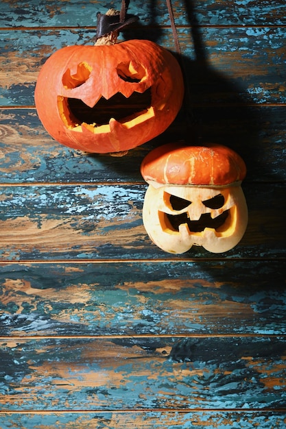 Pumpkins different size on wooden blue wall Carving A Pumpkin For Halloween