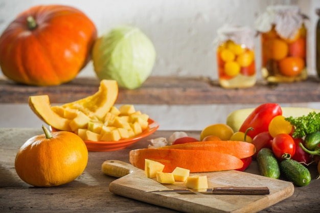 Pumpkins and other vegetables on wooden table