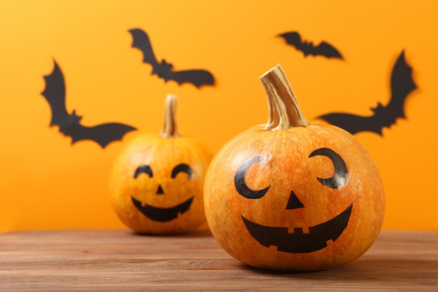 Pumpkins with painted faces on a colored background for halloween