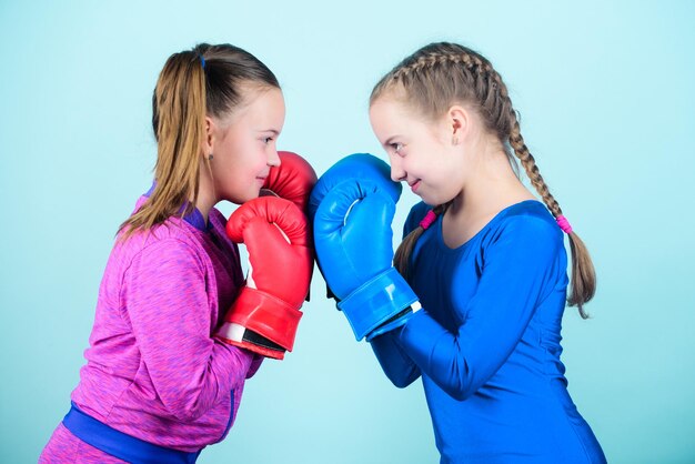 Photo punching knockout childhood activity fitness diet energy health workout of small girls boxer in sportswear sport success friendship happy children sportsman in boxing gloves simply the best