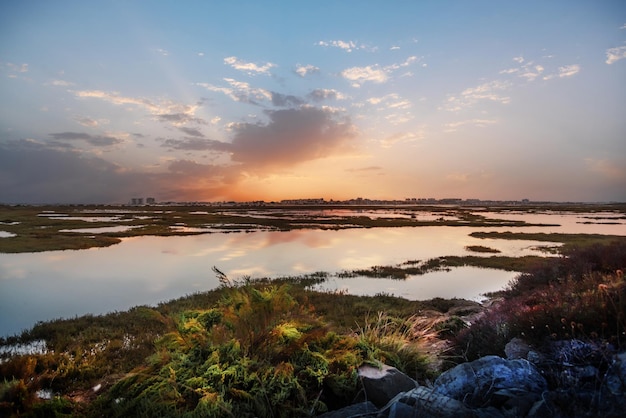 Punta Umbria from the marshes of Huelva Spain in a beautiful sunset with a sky full of clouds