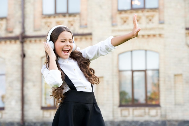 Pupil listen music back to school happy beauty singing outdoor kid innovating education through audio book happy childrens day modern look of schoolgirl retro kid in uniform and headset