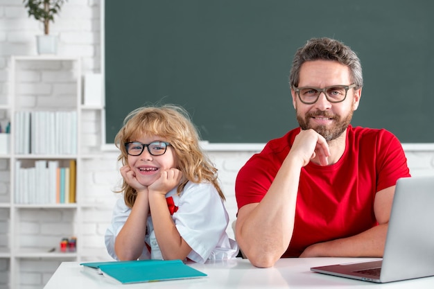 Pupil of primary elementary school has lesson kid boy with teacher learn english language or mathema