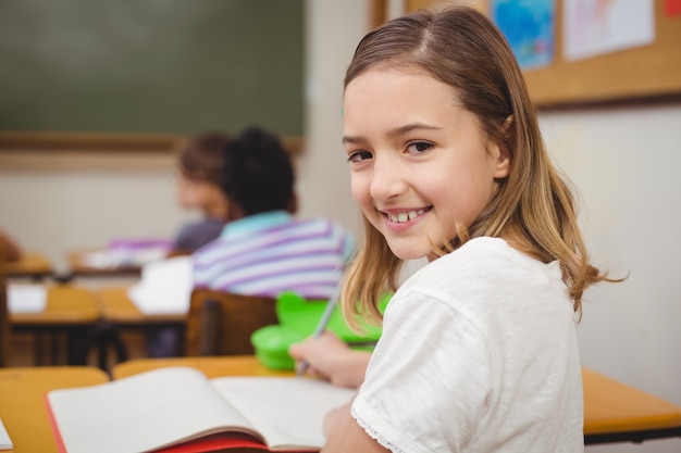 Pupil smiling at camera during class