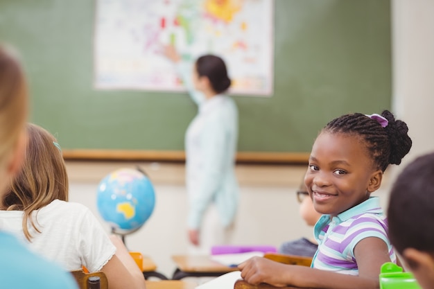 Pupil smiling at camera during class