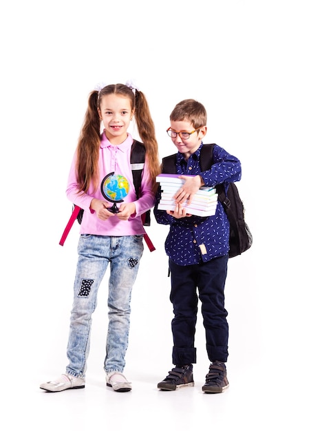 Pupils boy and girl isolated on the white background. Teenagers with backpacks holding books in the hands