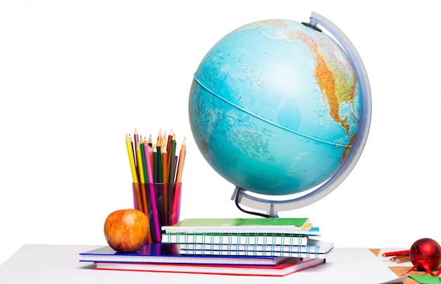 Pupils desk with books and globe