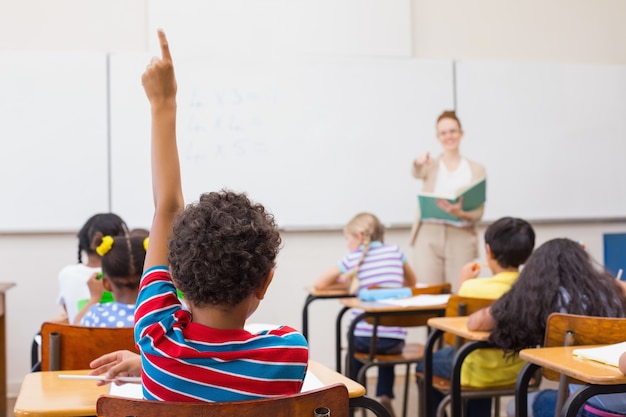 Pupils raising hand in classroom