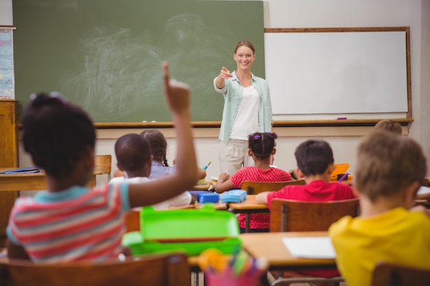 Pupils raising their hands during class