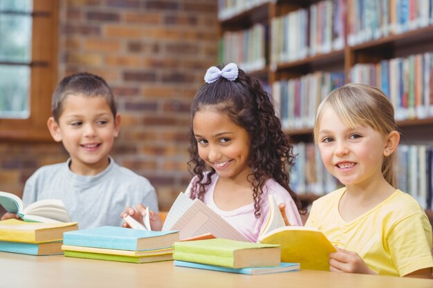 Pupils reading books in library