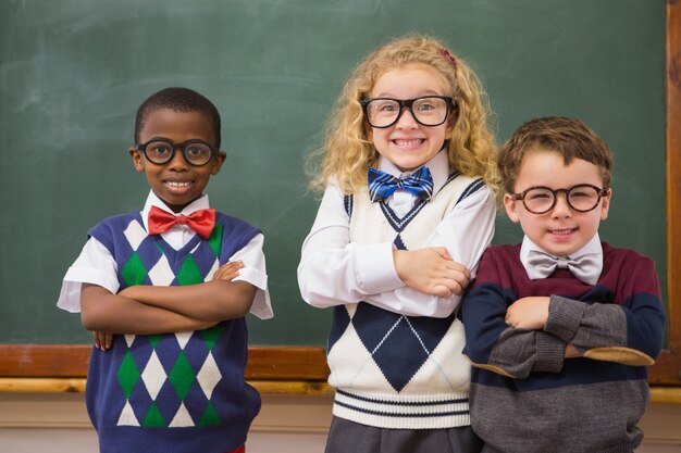 Pupils smiling at camera with arms crossed 