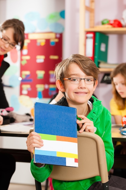 Pupils and teacher learning at school