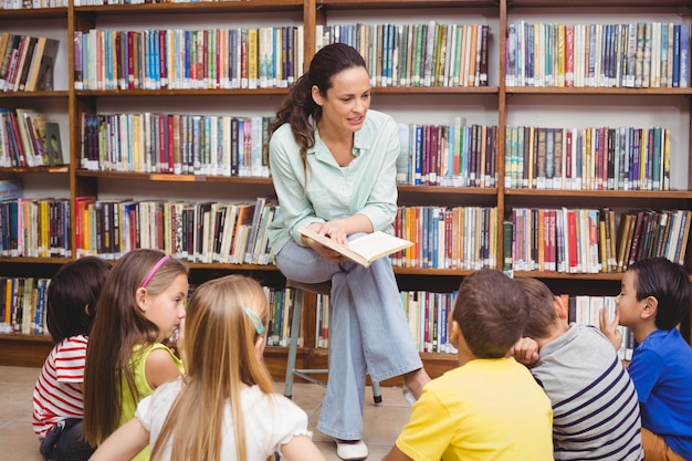 Pupils and teacher in the library using computer