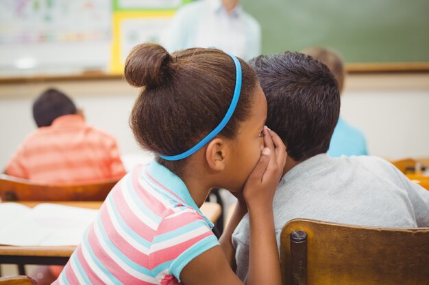 Pupils whispering secrets during class 