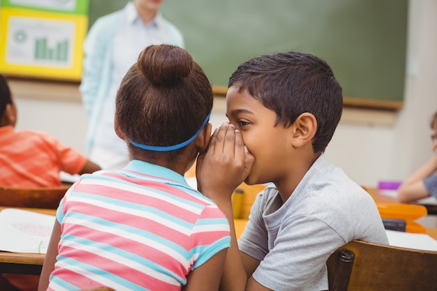 Pupils whispering secrets during class 