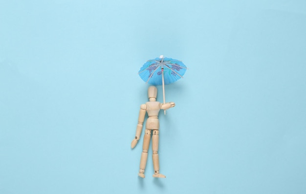 Photo puppet with umbrella on a blue background