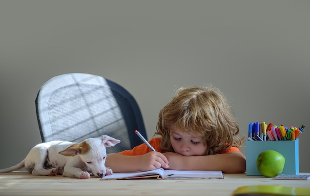 Puppy helping kid child with education learning studying at home