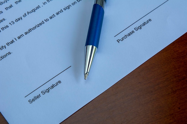 A Purchase agreement with a pen on a desk