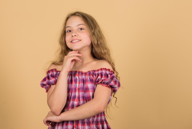 Pure beauty beautiful little girl fashion model small kid in dress happy small girl with long healthy hair hair health and care hairdresser salon beauty kid fashion long blond curly hair