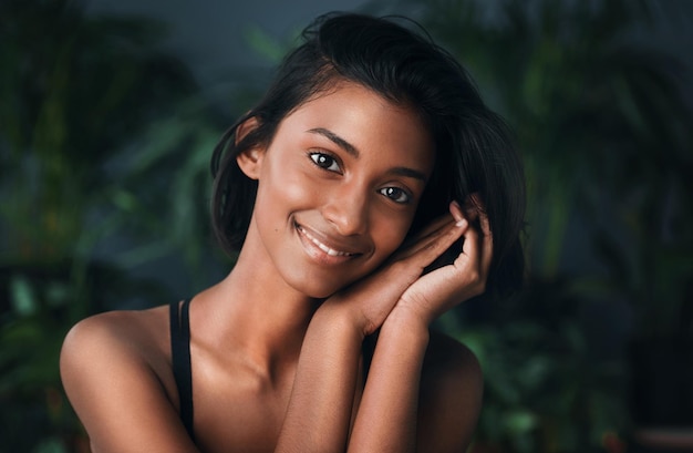 Pure beauty lies in being your unique self Shot of a beautiful young woman posing against a dark background