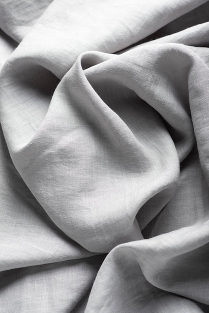 Pure linen fabric in grey color, selective focus image