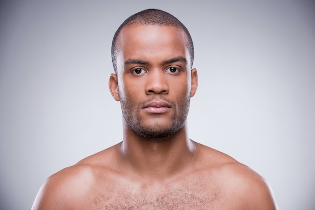 Pure masculinity. Portrait of young shirtless African man looking at camera 