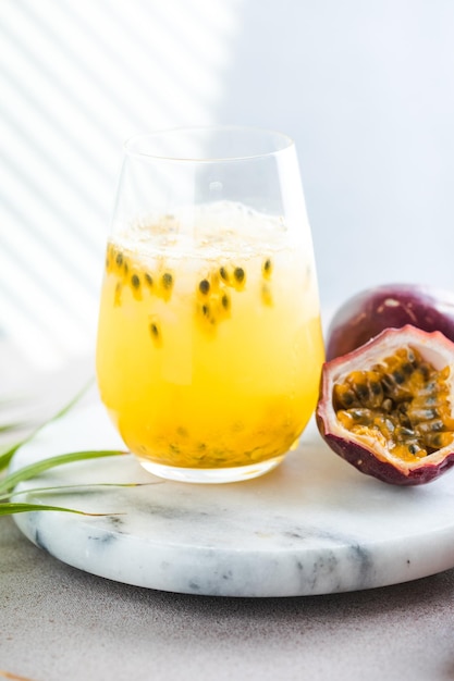 Pure passion alcoholic cocktail with syrup lime orange juice soda ice and passion fruit