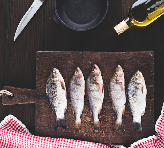 Purified river fish from the scales on brown wooden board