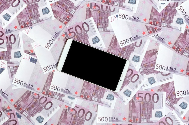 Purple 500 euro money bills and a smartphone with black screen