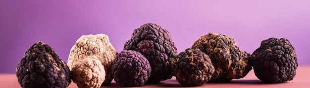 A purple background with black fruit