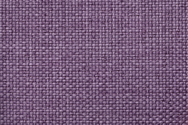 Purple background with braided checkered pattern, closeup. Texture of the weaving fabric, macro.