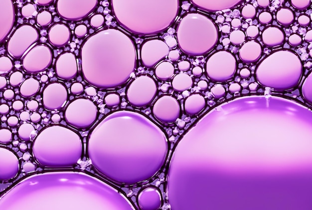 A purple background with a purple and pink circles and bubbles.