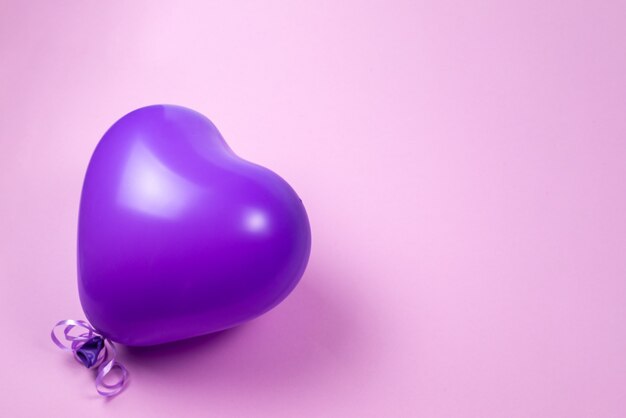 Purple ballon on purple background. Copy space.