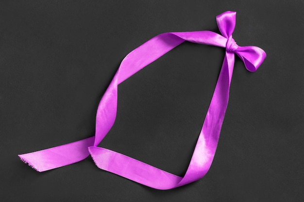 Purple bow on black background