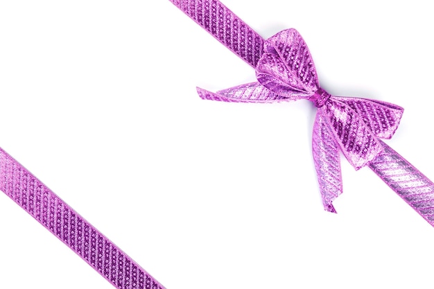 Фиолетовый бант, перевязанный шелковой лентой, изолированной на белой поверхности