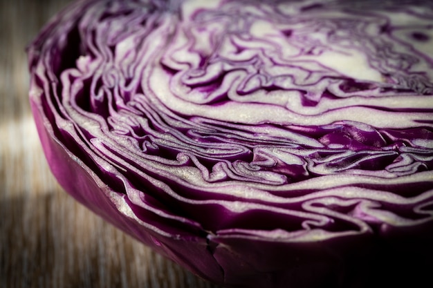 Purple cabbage lit on a wooden table.