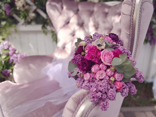 A purple chair with a bouquet of flowers on it