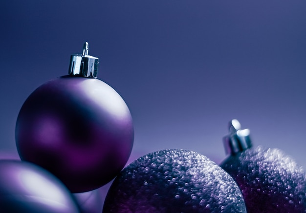 Purple christmas baubles as festive winter holiday background