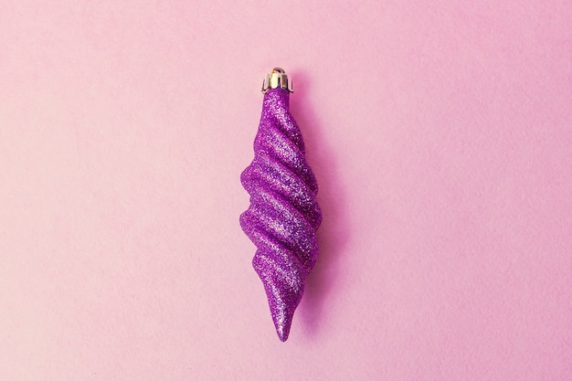 Purple Christmas tree toy on a pink background